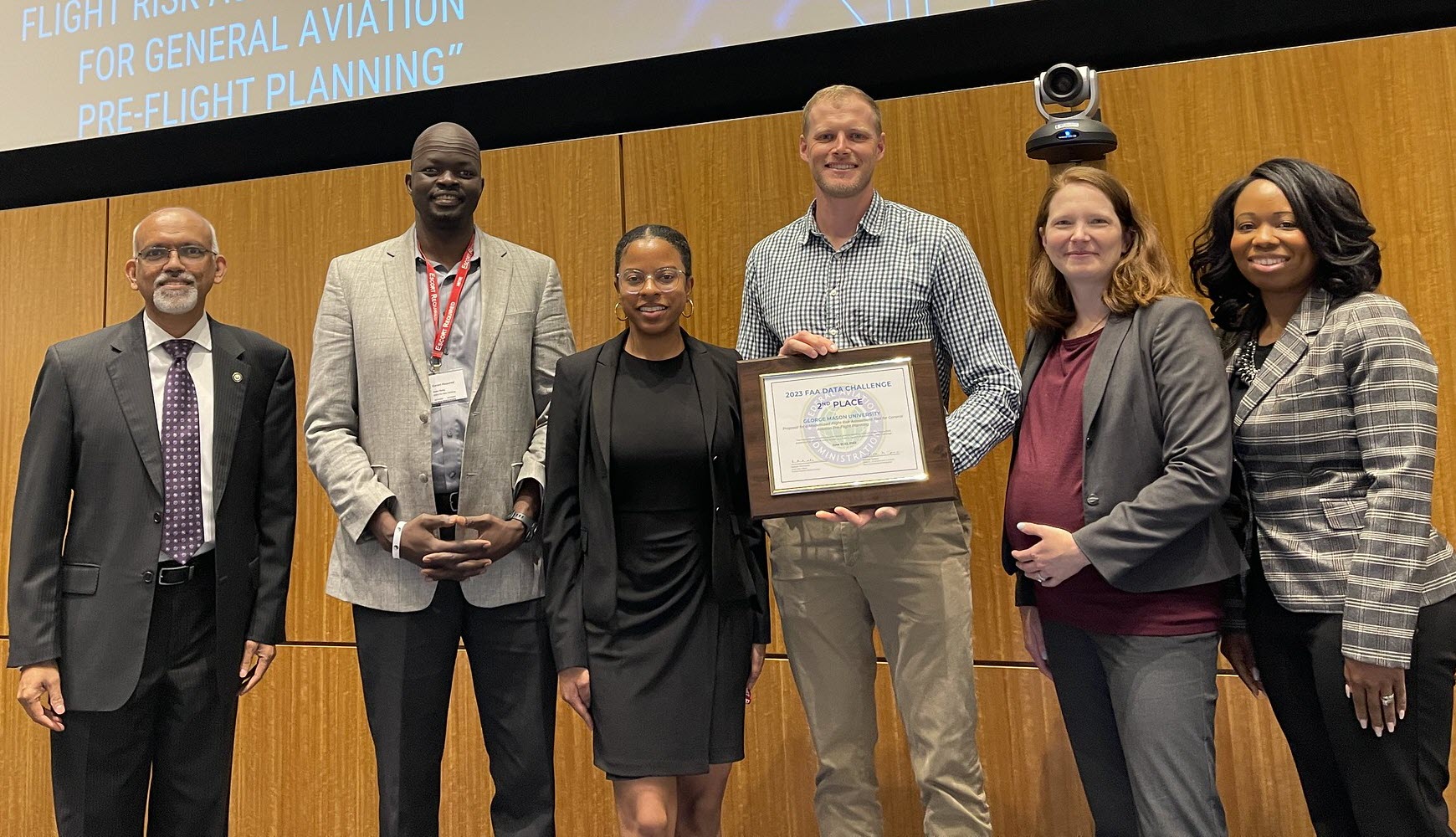 Natesh Manikoth and Marseta Dill present George Mason University with the 2nd place plaque